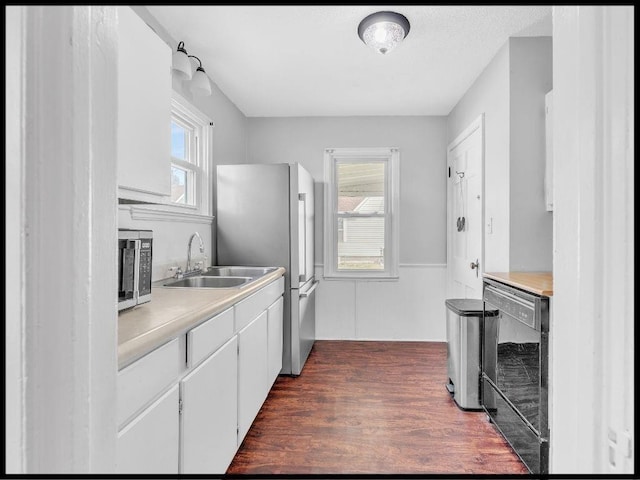 165 S Miami Ave, Marshall, MO 65340 - kitchen with plenty of natural light, wainscoting, appliances with stainless steel finishes, a sink, and dark wood-style floors