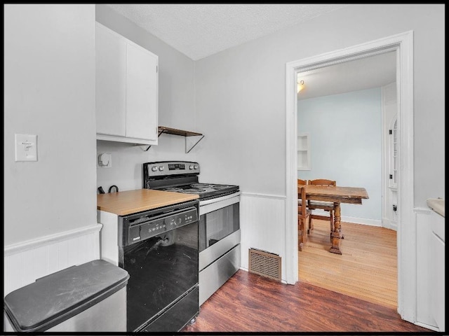 165 S Miami Ave, Marshall, MO 65340 - kitchen featuring stainless steel electric range oven, dark wood-type flooring, white cabinetry, light countertops, and dishwasher