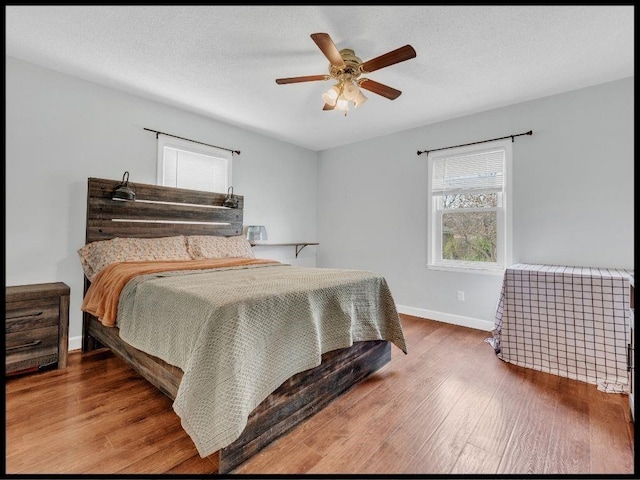 165 S Miami Ave, Marshall, MO 65340 - bedroom featuring ceiling fan, wood finished floors, and baseboards