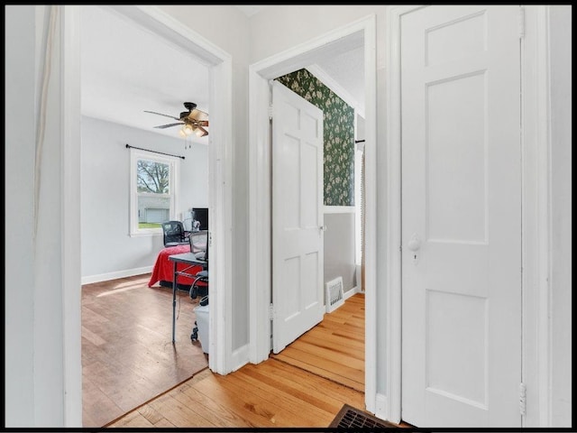 165 S Miami Ave, Marshall, MO 65340 - corridor featuring visible vents, baseboards, and light wood-style floors