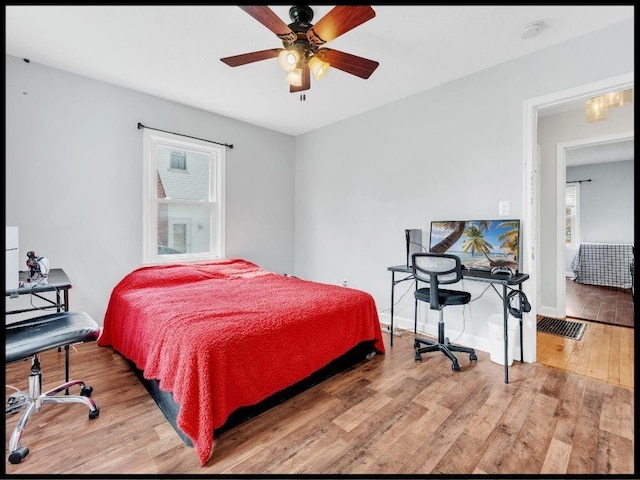 165 S Miami Ave, Marshall, MO 65340 - bedroom with wood finished floors, a ceiling fan, and baseboards