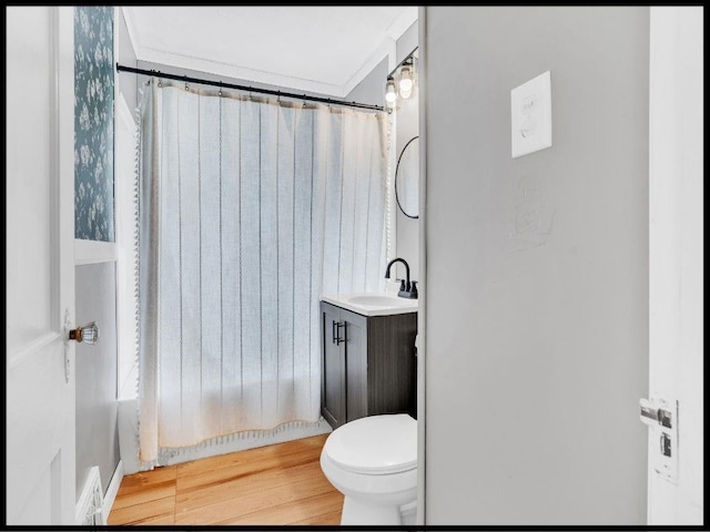 165 S Miami Ave, Marshall, MO 65340 - bathroom with wood finished floors, toilet, and vanity