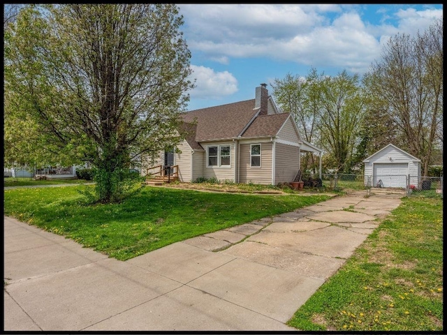 165 S Miami Ave, Marshall, MO 65340 - view of front of home with an outbuilding, a front yard, a garage, and fence