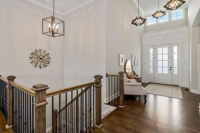 1904 NE 114th Ter, Kansas City, MO 64155 - entryway featuring wood finished floors, an inviting chandelier, a high ceiling, and ornamental molding