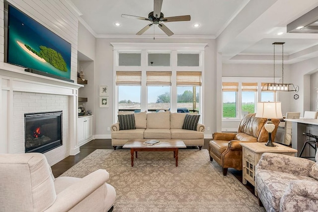 1904 NE 114th Ter, Kansas City, MO 64155 - living area with ornamental molding, recessed lighting, dark wood-style floors, a ceiling fan, and a brick fireplace