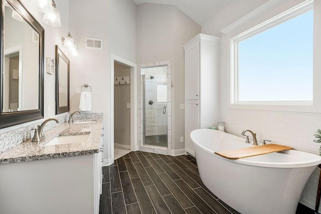 1904 NE 114th Ter, Kansas City, MO 64155 - full bathroom featuring a sink, visible vents, a freestanding bath, and a stall shower