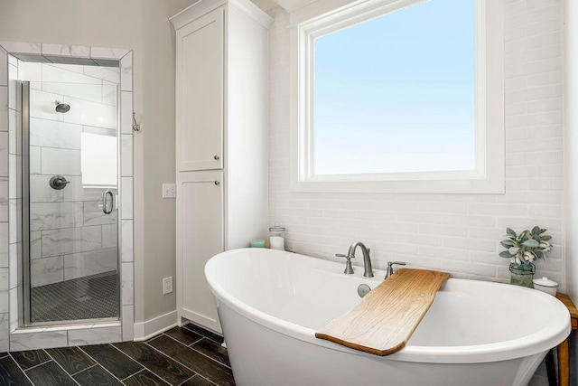 1904 NE 114th Ter, Kansas City, MO 64155 - bathroom featuring a freestanding bath, baseboards, a shower stall, and wood finish floors