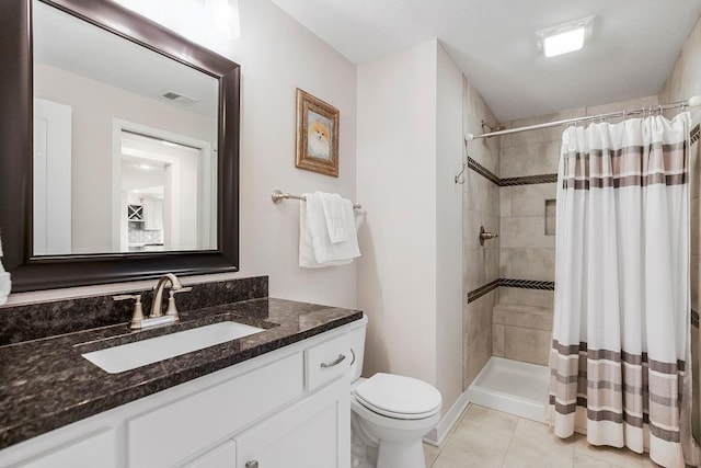 1904 NE 114th Ter, Kansas City, MO 64155 - bathroom featuring visible vents, toilet, a tile shower, vanity, and tile patterned floors