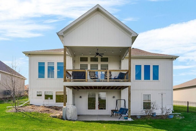 1904 NE 114th Ter, Kansas City, MO 64155 - rear view of house featuring a patio, a balcony, a ceiling fan, fence, and a lawn