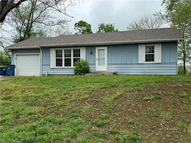 ranch-style home featuring a garage, board and batten siding, and a front yard