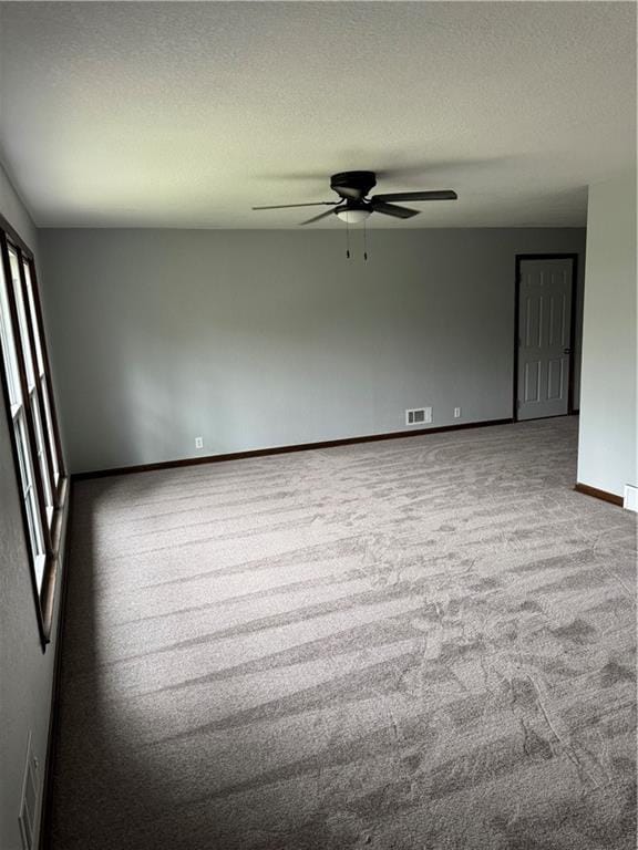 616 Prospect St, Excelsior Springs, MO 64024 - spare room with ceiling fan, a textured ceiling, visible vents, baseboards, and carpet