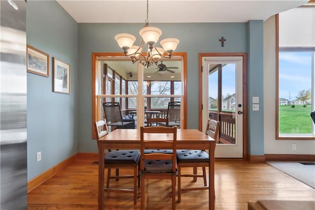 dining area featuring wood finished floors, baseboards, and a wealth of natural light