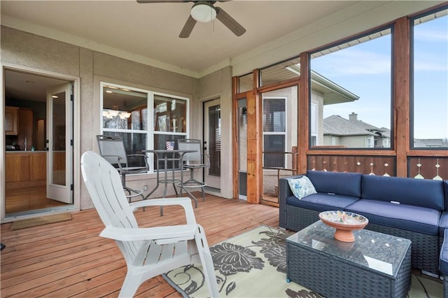 sunroom featuring ceiling fan, a wealth of natural light, and an outdoor hangout area