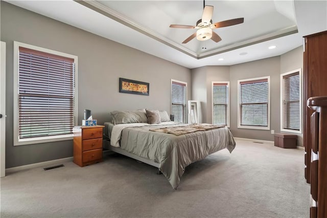bedroom with visible vents, baseboards, a tray ceiling, recessed lighting, and light carpet