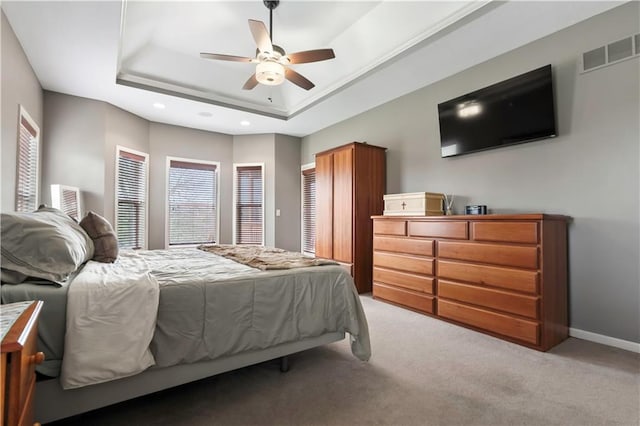 bedroom featuring baseboards, recessed lighting, visible vents, a raised ceiling, and carpet