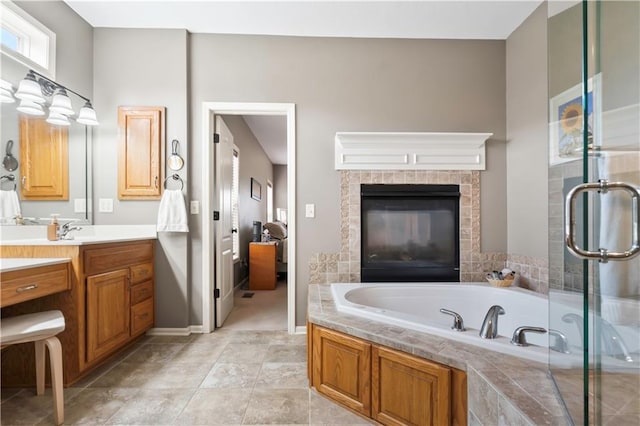 bathroom with a shower stall, vanity, and a garden tub