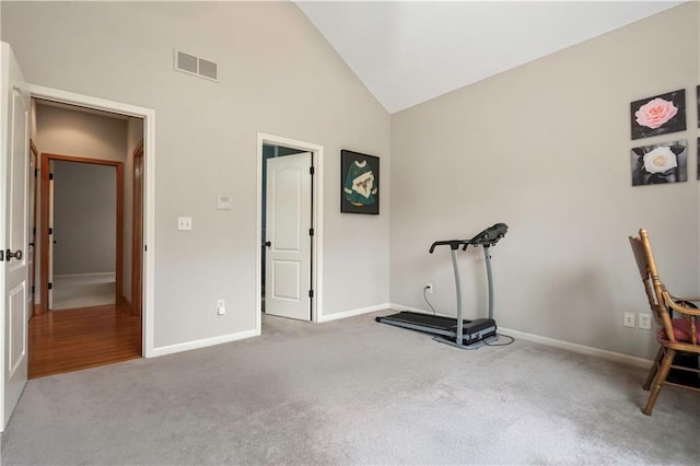 workout room featuring visible vents, baseboards, high vaulted ceiling, and carpet flooring