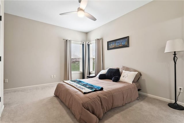 bedroom featuring light carpet, baseboards, and a ceiling fan