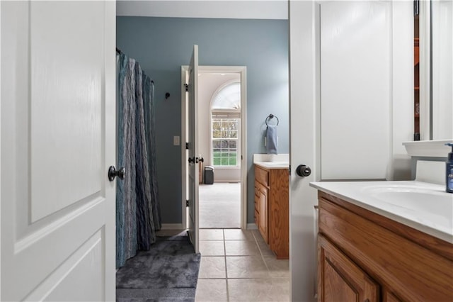 full bath featuring tile patterned flooring, vanity, and curtained shower