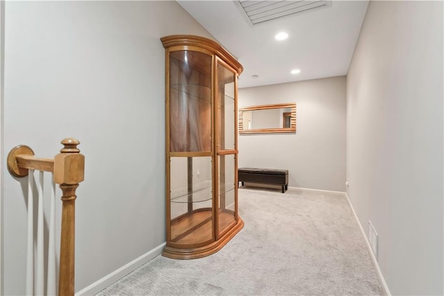 corridor featuring visible vents, baseboards, recessed lighting, and carpet flooring