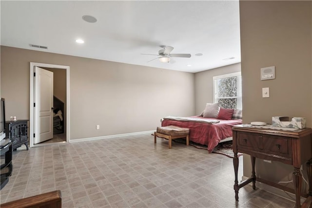 bedroom featuring visible vents, baseboards, a wood stove, ceiling fan, and recessed lighting