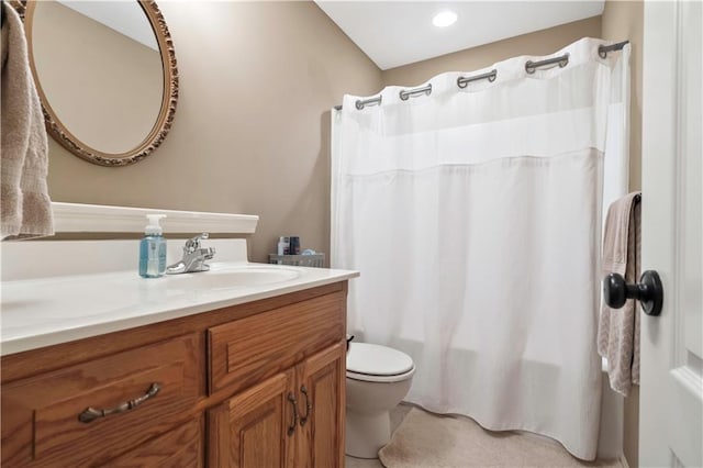 bathroom with toilet, vanity, and shower / bath combo with shower curtain