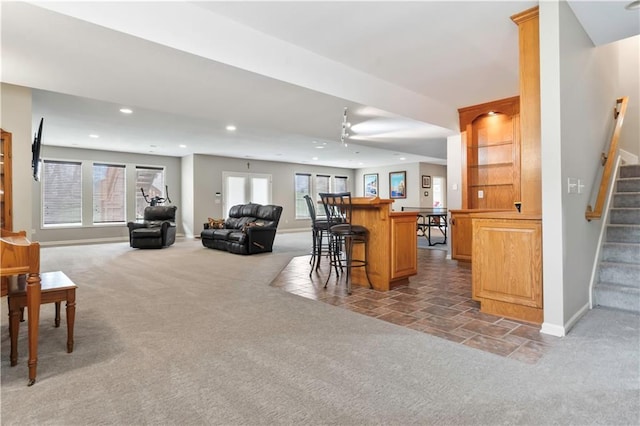 interior space featuring light carpet, recessed lighting, baseboards, and stairway