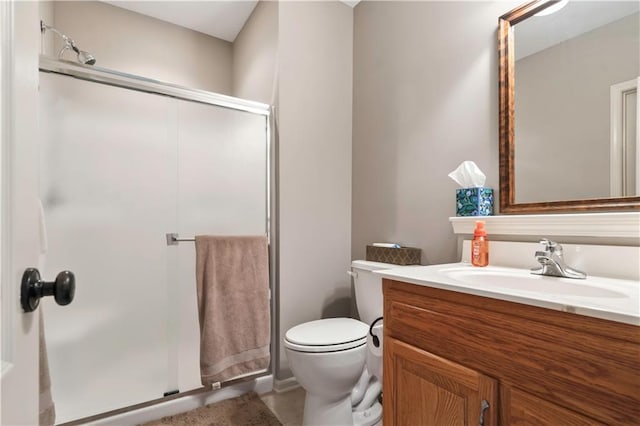 bathroom with toilet, a stall shower, and vanity