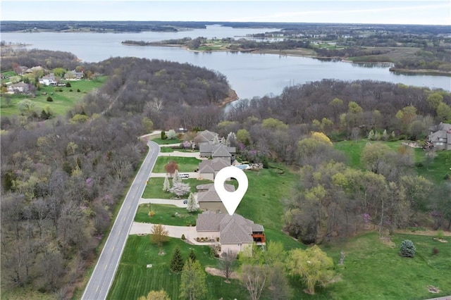 bird's eye view with a water view and a view of trees