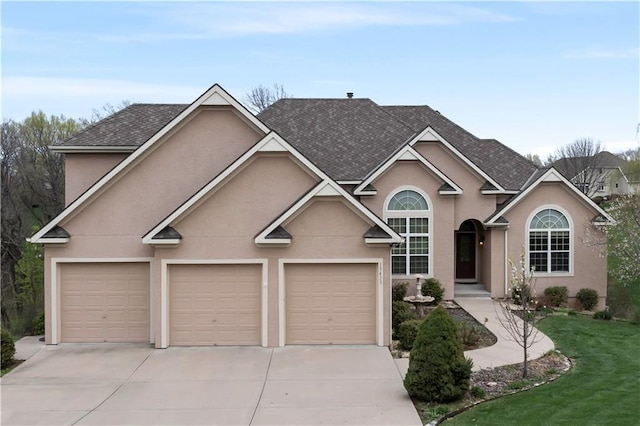 view of front of house featuring a garage, roof with shingles, driveway, and stucco siding