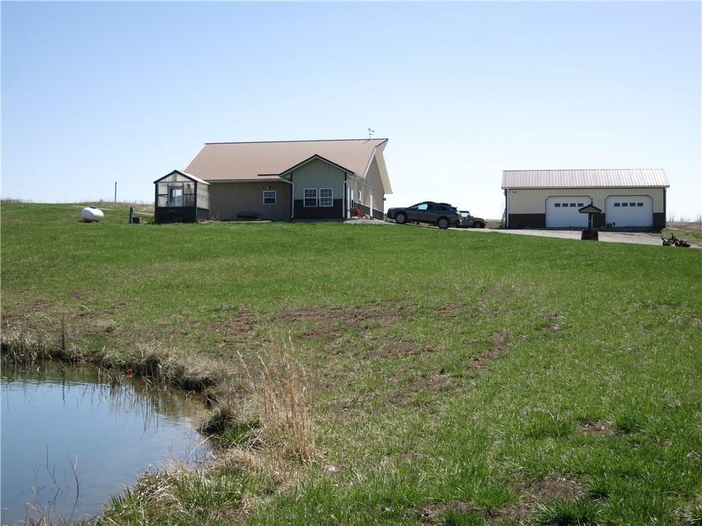 view of side of property featuring a lawn and a garage
