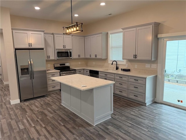 101 N Maple St, Butler, MO 64730 - kitchen with appliances with stainless steel finishes, dark wood-style floors, a sink, gray cabinetry, and recessed lighting