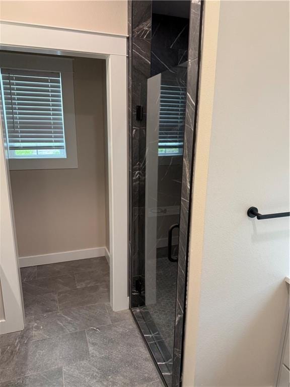 101 N Maple St, Butler, MO 64730 - full bathroom featuring a shower stall and baseboards