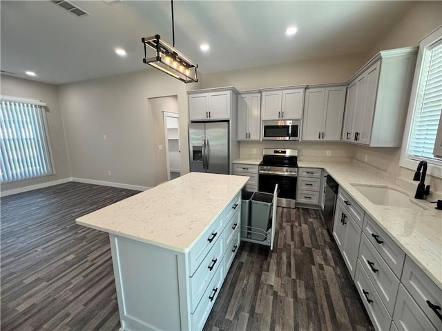 101 N Maple St, Butler, MO 64730 - kitchen featuring stainless steel appliances, a sink, dark wood finished floors, a center island, and recessed lighting