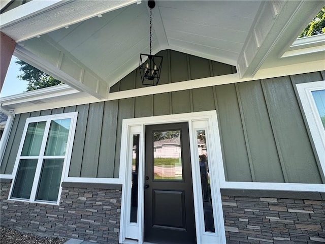 101 N Maple St, Butler, MO 64730 - doorway to property featuring board and batten siding