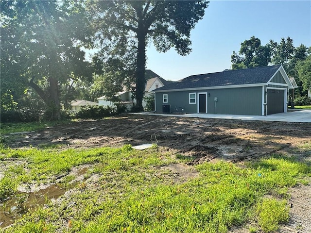 101 N Maple St, Butler, MO 64730 - view of property exterior featuring a garage and concrete driveway