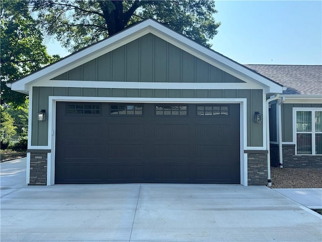 101 N Maple St, Butler, MO 64730 - view of front of home featuring stone siding, board and batten siding, and roof with shingles