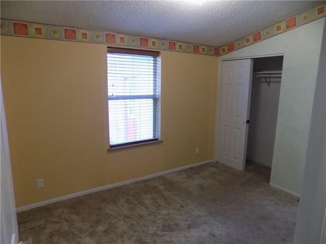 518 S Pine, Ottawa, KS 66067 - unfurnished bedroom featuring a closet, baseboards, carpet, and a textured ceiling