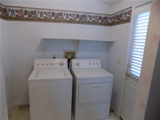 518 S Pine, Ottawa, KS 66067 - laundry room featuring laundry area, washing machine and clothes dryer, and a wealth of natural light