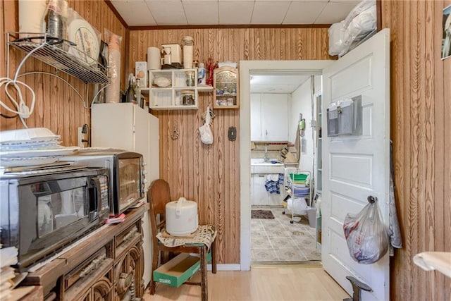 interior space with wood walls and black microwave