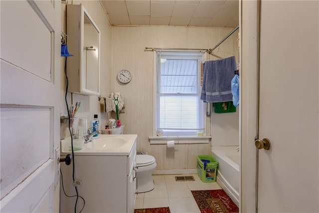 bathroom featuring visible vents, toilet, shower / bath combination, vanity, and tile patterned flooring