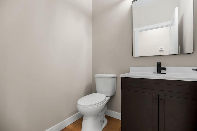 284 SW 1311th Rd, Holden, MO 64040 - bathroom featuring baseboards, vanity, toilet, and wood finished floors