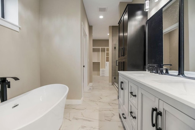 284 SW 1311th Rd, Holden, MO 64040 - bathroom with marble finish floors, a freestanding bath, double vanity, a spacious closet, and recessed lighting