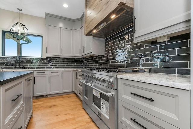 284 SW 1311th Rd, Holden, MO 64040 - kitchen featuring double oven range, custom exhaust hood, decorative backsplash, a chandelier, and recessed lighting