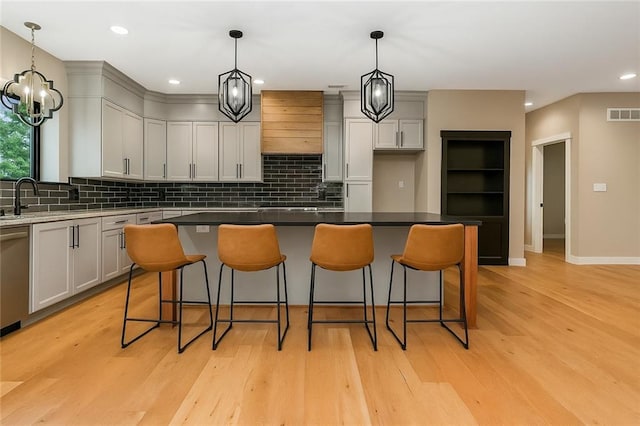 284 SW 1311th Rd, Holden, MO 64040 - kitchen featuring backsplash, light wood finished floors, a breakfast bar, dishwasher, and recessed lighting