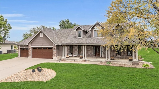 view of front of property with a garage, a front yard, brick siding, a porch, and driveway