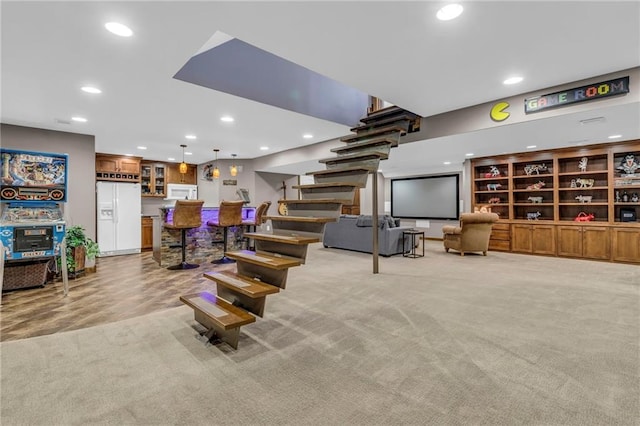 interior space featuring recessed lighting, light carpet, stairway, and indoor bar
