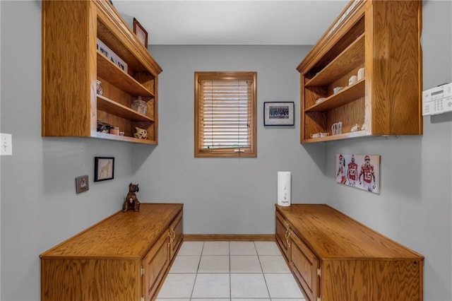 interior space featuring light tile patterned floors and baseboards