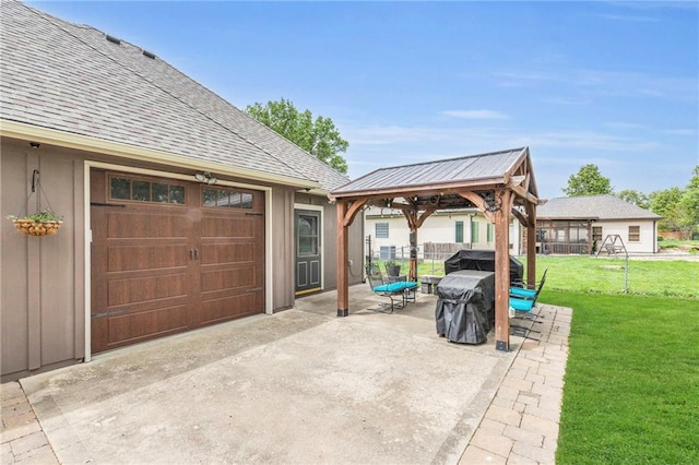 view of patio featuring concrete driveway, a gazebo, and fence
