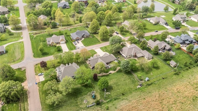 birds eye view of property featuring a water view and a residential view
